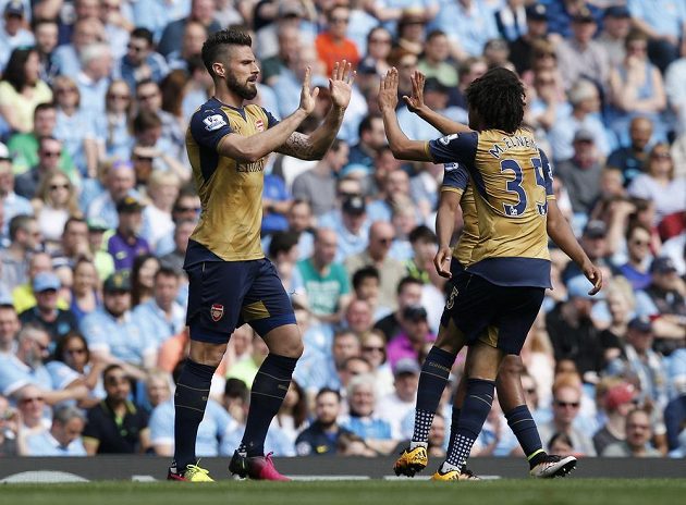 Olivier Giroud (vlevo) a Mohamed Elneny z Arsenalu oslavují vstřelenou branku do sítě Manchesteru City.