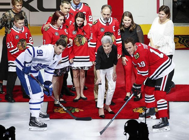 Manželka Stana Mikity Jill vhazuje buly mezi útočníka Toronta Johna Tavarese (vlevo) a chicagského Jonathana Toewse.