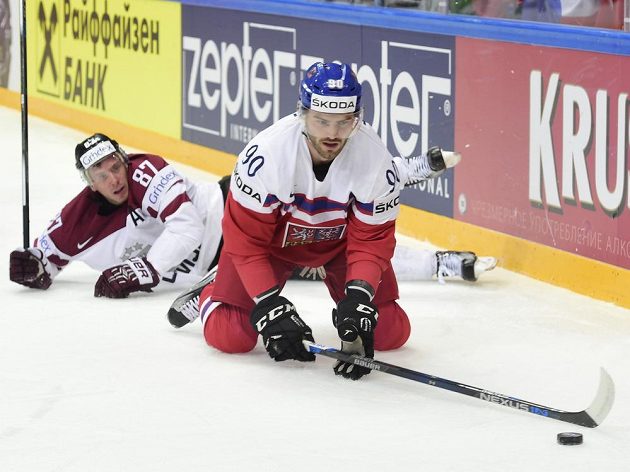 Lotyšský reprezentant Gints Meija (v pozadí) sleduje českého útočníka Roberta Kousala.