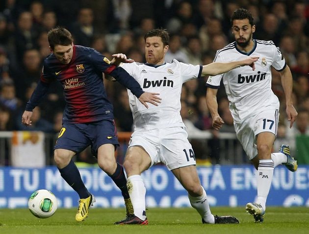 Unikajícího dirigenta Barcelony Lionela Messiho se snaží zastavit Xabi Alonso z Realu Madrid (uprostřed). Zcela vpravo je Álvaro Arbeloa.