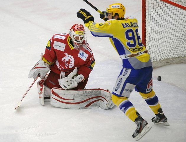 Třinecký brankář Šimon Hrubec (vlevo) inkasuje gól na ledě Zlína, vpravo se raduje domácí Jaroslav Balaštík.
