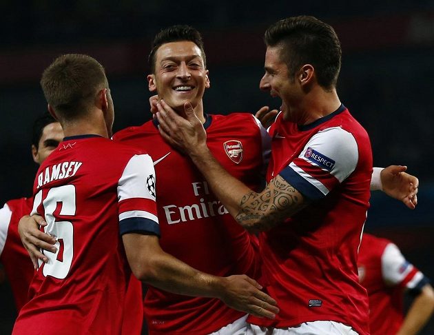 Mesut Özil (uprostřed), autor úvodní trefy Arsenalu v duelu Ligy mistrů s Neapolí, oslavuje gól se spoluhráči Aaronem Ramseym a Olivierem Giroudem (vpravo).