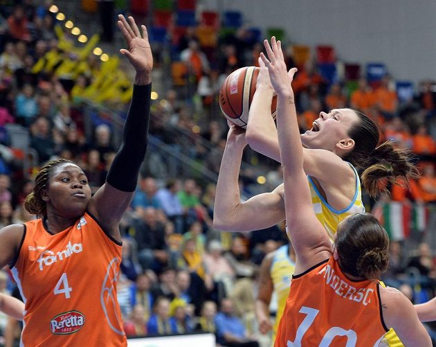 Basketbalistka USK Anete Steinbergaová se snaží prosadit mezi dvojicí hráček ze Schia. Vlevo je Isabelle Yacoubouvá, vpravo pak Jolene Andersonová.