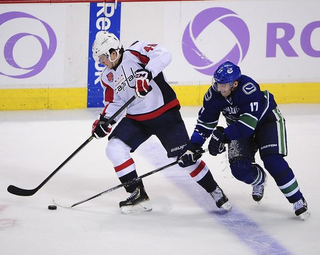 Radim Vrbata (17) z Vancouveru Canucks se snaží sebrat kotouč Michaelu Lattovi z Washhingtonu.