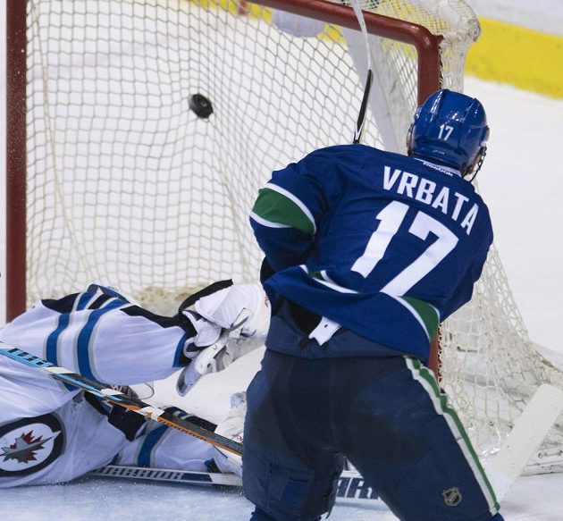Útočník Vancouveru Radim Vrbata střílí gól brankáři Winnipegu Michaelu Hutchinsonovi.