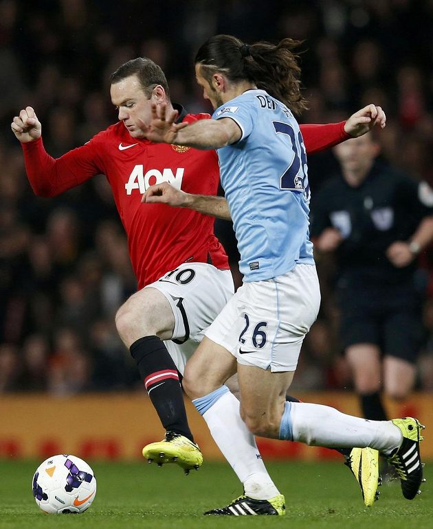 Wayne Rooney (vlevo) z Manchesteru United v souboji s Martinem Demichelisem z Manchesteru City.