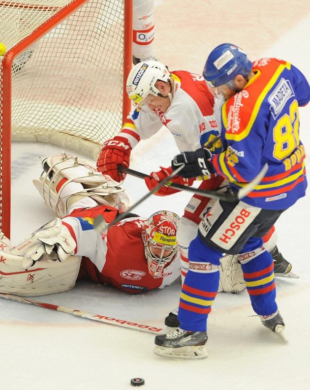 Dramatická situace před brankářem Slavie Dominikem Furchem: o puk bojují další slávista Jakub Šulc a budějovický Daniel Boháč.