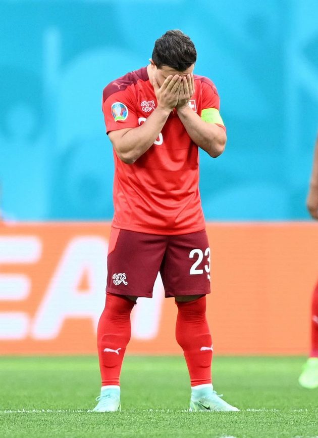 Swiss footballer Xherdan Shaqiri hides his head in his hands during the EURO quarterfinals with Spain.