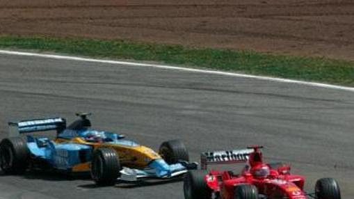 Fernando Alonso na renaultu (vlevo) stíhí ferrari Michaela Schumachera (vpravo) a Rubense Barrichella.