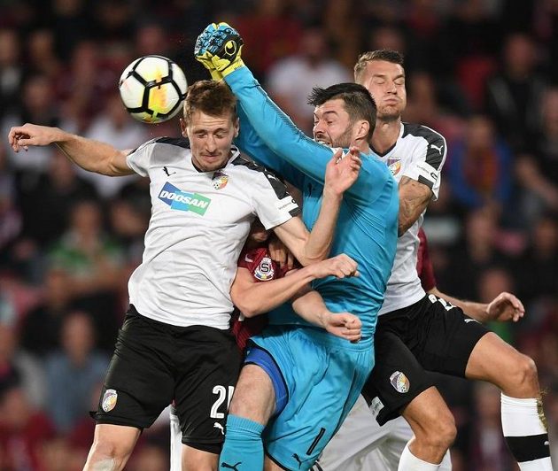 Brankář Plzně Matúš Kozáčik vyráží s pomocí spoluhráčů míč v duelu se Spartou.