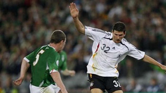Německý fotbalista Mario Gomez se snaží přejít přes irského Richarda Dunneho Německý fotbalista Mario Gomez se snaží přejít přes irského Richarda Dunneho