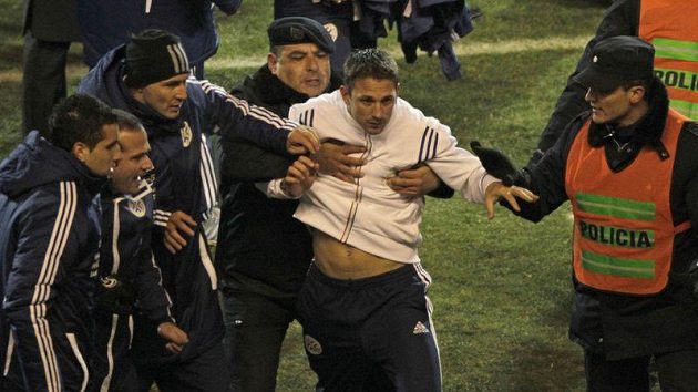Policisté pacifikují člena venezuelského týmu, který se zapojil do bitky s Paraguayí po semifinále mistrovství Jižní Amriky. Policisté pacifikují člena venezuelského týmu, který se zapojil do bitky s Paraguayí po semifinále mistrovství Jižní Amriky.