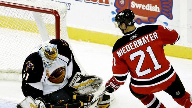 Brankář Atlanty Ondřej Pavelec zasahuje před Robem Niedermayerem z New Jersey Brankář Atlanty Ondřej Pavelec zasahuje před Robem Niedermayerem z New Jersey