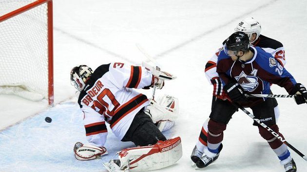 Brankář New Jersey Martin Brodeur dostává gól od českého obránce Hejdy, přihlíží jeho spoluhráč Paul Stastny Brankář New Jersey Martin Brodeur dostává gól od českého obránce Hejdy, přihlíží jeho spoluhráč Paul Stastny