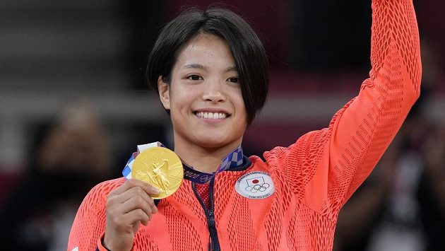 Olympijská vítězka Uta Abeová pózuje se zlatou medailí. Olympijská vítězka Uta Abeová pózuje se zlatou medailí.