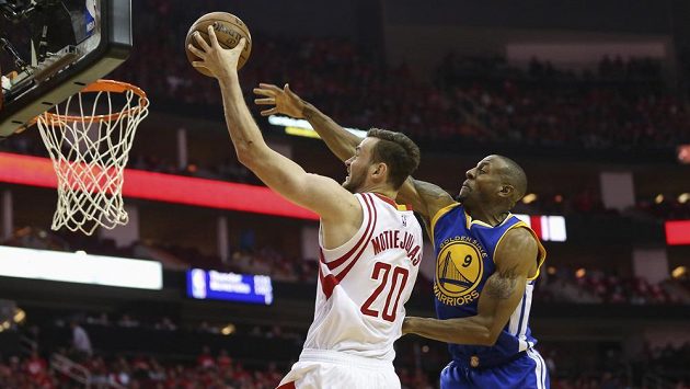 Donatas Motiejunas z Houstonu (vlevo) a bránící Andre Iguodala z Golden State. Donatas Motiejunas z Houstonu (vlevo) a bránící Andre Iguodala z Golden State.