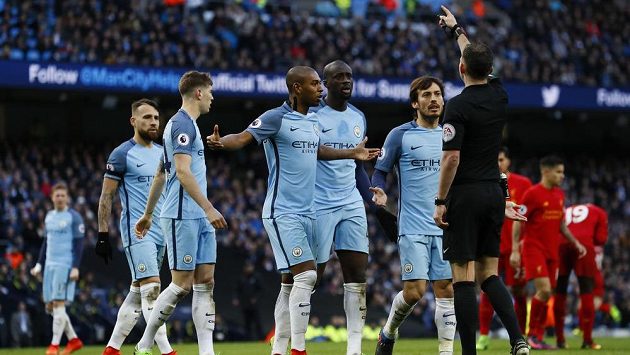Fotbalisté Manchesteru City protestují u rozhodčího Michaela Olivera po odpískané penaltě v zápase Premier League proti Liverpoolu. Fotbalisté Manchesteru City protestují u rozhodčího Michaela Olivera po odpískané penaltě v zápase Premier League proti Liverpoolu.