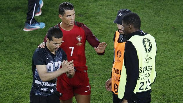 Cristiano Ronaldo domlouvá pořadatelům. S fanouškem, který vnikl na hrací plochu, se ochotně vyfotil. Cristiano Ronaldo domlouvá pořadatelům. S fanouškem, který vnikl na hrací plochu, se ochotně vyfotil.