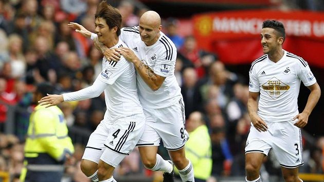 Ki Song-jung (vlevo) ze Swansea slaví gól na Old Trafford proti Manchesteru United. Ki Song-jung (vlevo) ze Swansea slaví gól na Old Trafford proti Manchesteru United.