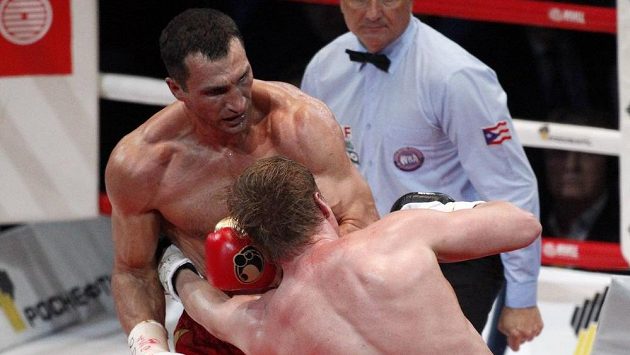Alexandr Povětkin inkasuje tvrdý úder od Vladimira Klička v mistrovském duelu organizací WBO, IBF a IBO. Alexandr Povětkin inkasuje tvrdý úder od Vladimira Klička v mistrovském duelu organizací WBO, IBF a IBO.