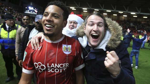 Střelec rozhodující trefy bristolský Korey Smith slaví s fanouškem vítězství 2:1 ve čtvrtfinále anglického Ligového poháru nad Manchesterem United. Střelec rozhodující trefy bristolský Korey Smith slaví s fanouškem vítězství 2:1 ve čtvrtfinále anglického Ligového poháru nad Manchesterem United.