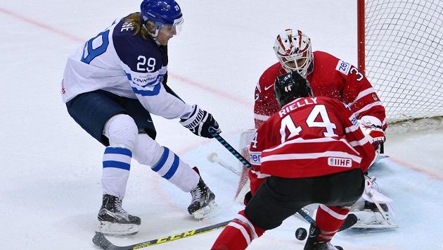 Fin Patrik Laine se snaží protlačit puk za záda kanadského gólmana Cama Talbota. Fin Patrik Laine se snaží protlačit puk za záda kanadského gólmana Cama Talbota.