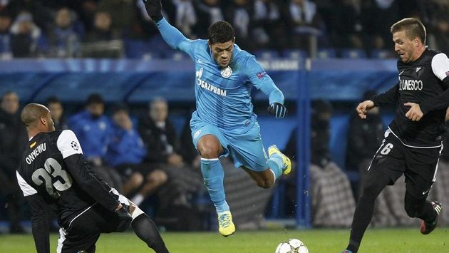Brazilský útočník Hulk ve službách Zenitu Petrohrad bojuje s obranou Málagy. Brazilský útočník Hulk ve službách Zenitu Petrohrad bojuje s obranou Málagy.