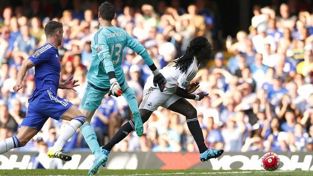 Útočník Swansea Bafetimbi Gomis padá po kontaktu s brankářem Thibautem Courtoisem. Útočník Swansea Bafetimbi Gomis padá po kontaktu s brankářem Thibautem Courtoisem.