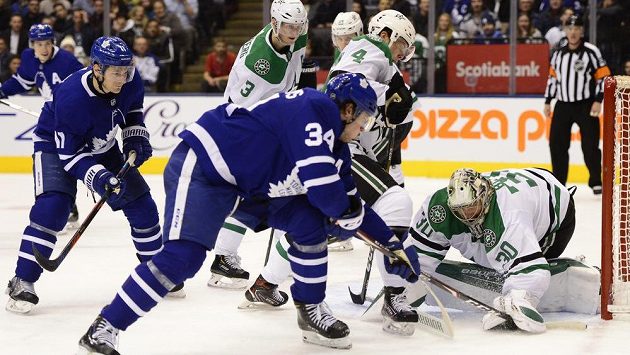 Centr Toronta Auston Matthews zkouší vydolovat puk zpod rukavice brankáře Bena Bishopa z Dallasu. Centr Toronta Auston Matthews zkouší vydolovat puk zpod rukavice brankáře Bena Bishopa z Dallasu.