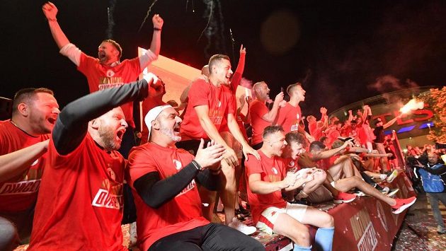 Rozjásaní fotbalisté Slavie slaví s fanoušky obhajobu titulu. Rozjásaní fotbalisté Slavie slaví s fanoušky obhajobu titulu.
