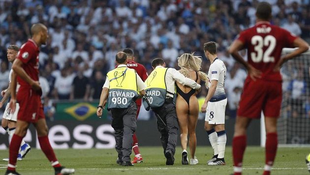 Polonahou krásku, která narušila finále fotbalové Ligy mistrů, vyprovázejí z trávníku strážci pořádku. Fotbalisté Liverpoolu vše pobaveně sledují. Polonahou krásku, která narušila finále fotbalové Ligy mistrů, vyprovázejí z trávníku strážci pořádku. Fotbalisté Liverpoolu vše pobaveně sledují.