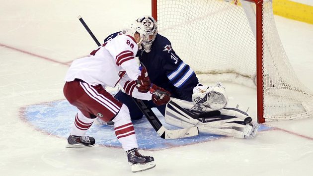 Brankář Winnipegu Ondřej Pavelec při zákroku proti útočníkovi Phoenixu Coyotes Mikkelu Boedkerovi. Brankář Winnipegu Ondřej Pavelec při zákroku proti útočníkovi Phoenixu Coyotes Mikkelu Boedkerovi.