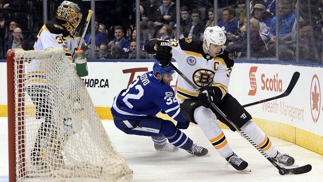 Slovenský kapitán Bostonu Zdeno Chára si kryje puk před dotírajícím Joshem Leivem z Toronta. Přihlíží gólman Bruins Anton Chudobin. Slovenský kapitán Bostonu Zdeno Chára si kryje puk před dotírajícím Joshem Leivem z Toronta. Přihlíží gólman Bruins Anton Chudobin.