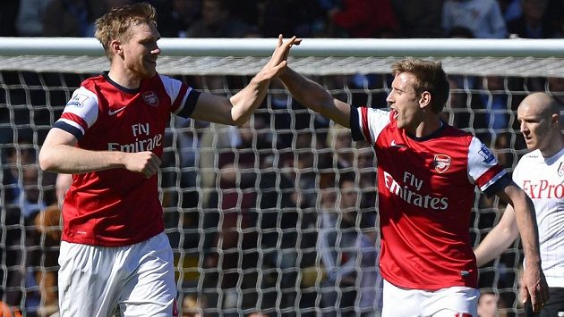 Per Mertesacker (vlevo) slaví gól proti Fulhamu s Nacho Monrealem. Per Mertesacker (vlevo) slaví gól proti Fulhamu s Nacho Monrealem.