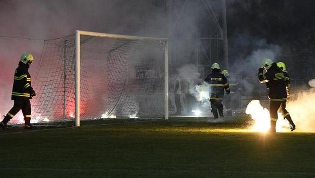 Hasiči sbírají z hřiště světlice, které tam v úvodu utkání naházeli fanoušci Sparty. Hasiči sbírají z hřiště světlice, které tam v úvodu utkání naházeli fanoušci Sparty.