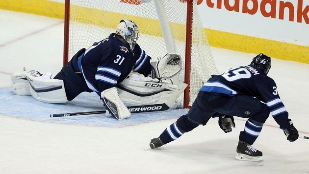 Brankář Winnipegu Ondřej Pavelec likviduje tutovku Brodziaka. Brankář Winnipegu Ondřej Pavelec likviduje tutovku Brodziaka.