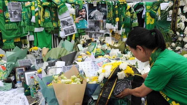 Čínská fanynka pokládá věnec k pietnímu místu za honduraského fotbalistu Waltera Martíneze. Čínská fanynka pokládá věnec k pietnímu místu za honduraského fotbalistu Waltera Martíneze.