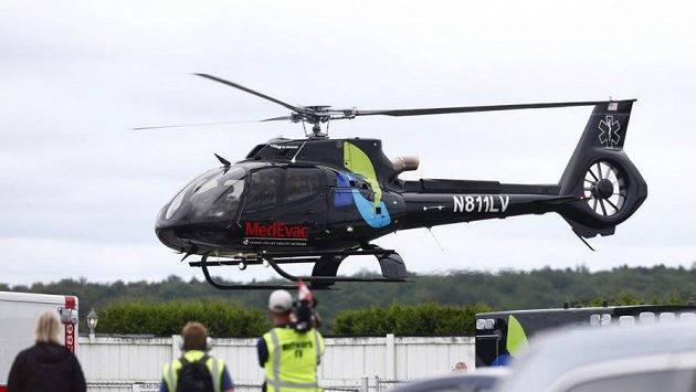 Vrtulník transportuje těžce zraněného kanadského pilota Roberta Wickense do nemocnice. Vrtulník transportuje těžce zraněného kanadského pilota Roberta Wickense do nemocnice.