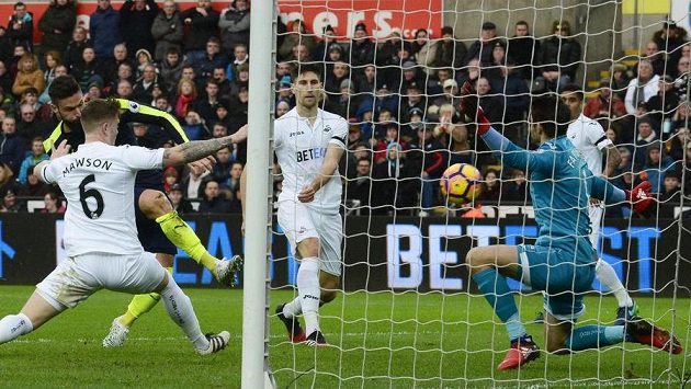 Olivier Giroud (v černém) z Arsenalu střílí úvodní gól utkání proti Swansea. Olivier Giroud (v černém) z Arsenalu střílí úvodní gól utkání proti Swansea.