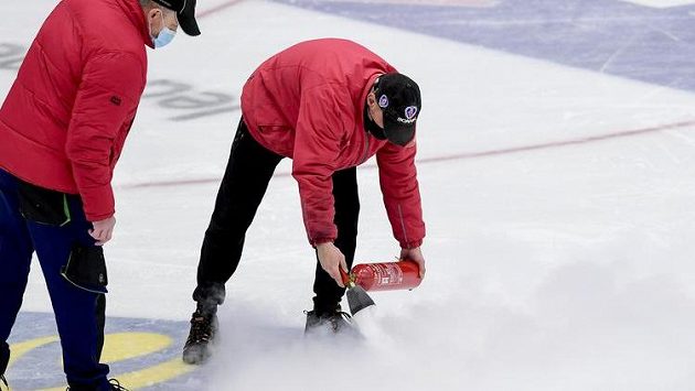 Pracovníci zimního stadionu opravují ledovou plochu. Pracovníci zimního stadionu opravují ledovou plochu.